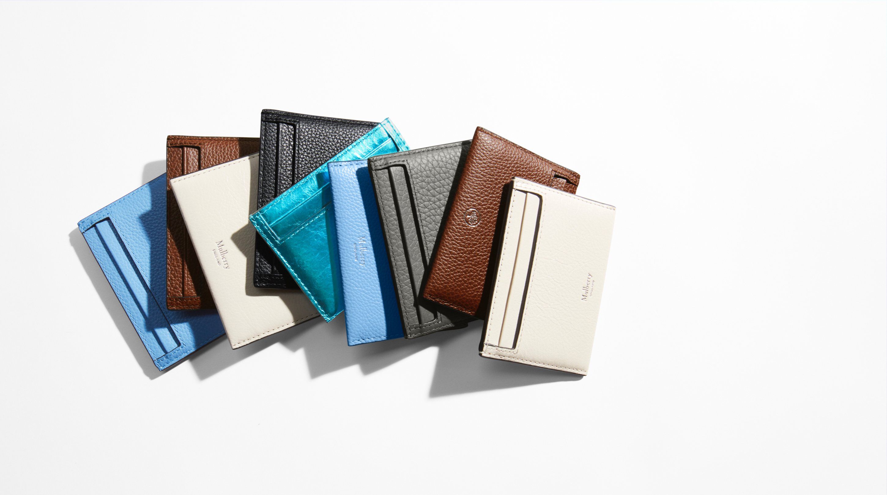 group of mulberry credit card slips in assorted colours of blue, brown, charcoal and chalk